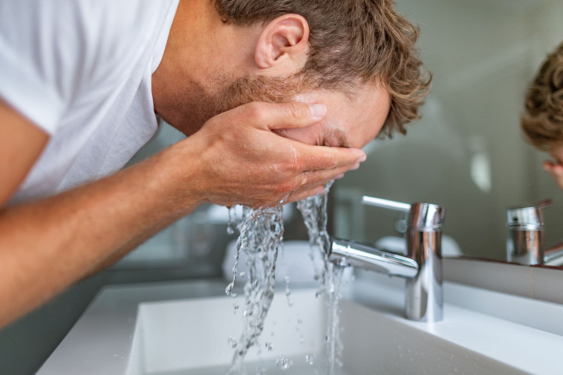 washing face in bathroom